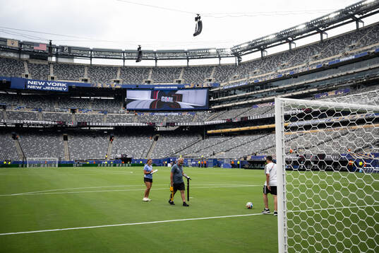 Staff observing the pitch at New York New Jersey Arena