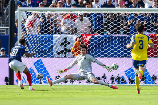 Kylian Mbappe of France and goalkeeper Jacob Widell