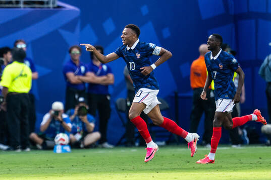 Kylian Mbappe of France celebrates with Ousmane Dembele