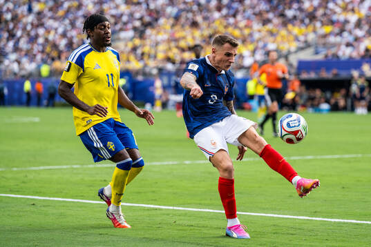 Anthony Elanga of Sweden and Lucas Digne of France