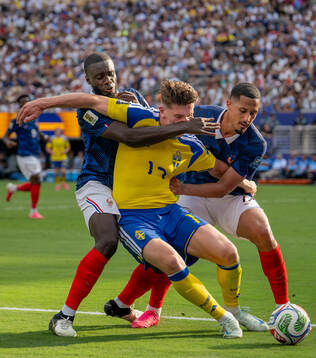 Viktor Gyökeres of Sweden in action with Dayot Upamecano