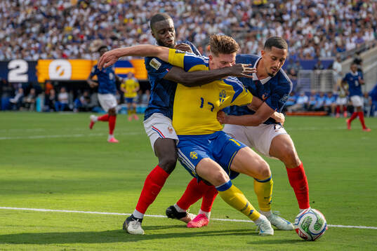 Viktor Gyökeres of Sweden in action with Dayot Upamecano