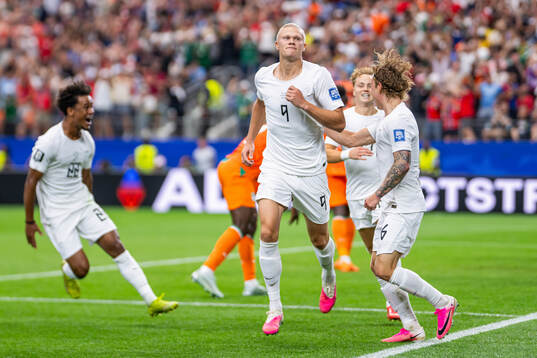 Erling Braut Haaland of Norway celebrates with Oscar Bobb,