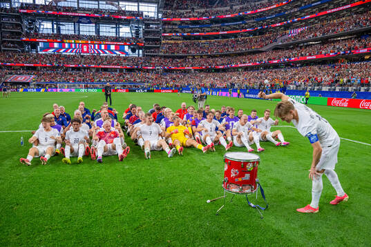 Players and staff of Norway celebrate with a viking row