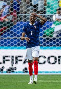 Michael Olise of France looks dejected