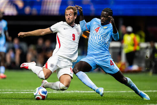 Harry Kane of England and Axel Tuanzebe of Congo DR