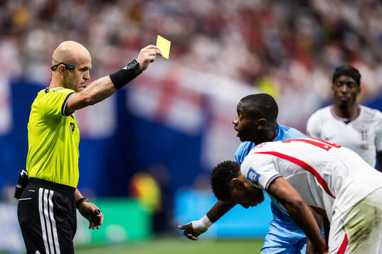 Noah Sadiki of Congo DR receives a warning