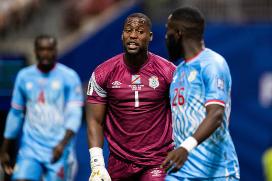 Goalkeeper Lionel Mpasi and Arthur Masuaku of Congo DR