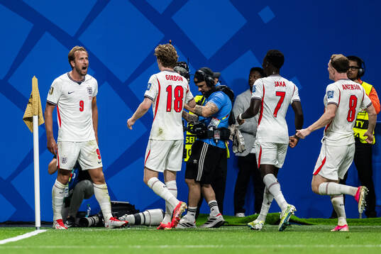 Harry Kane of England celebrates with teammates