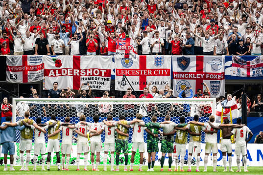 Supporters of England celebrate together with the team