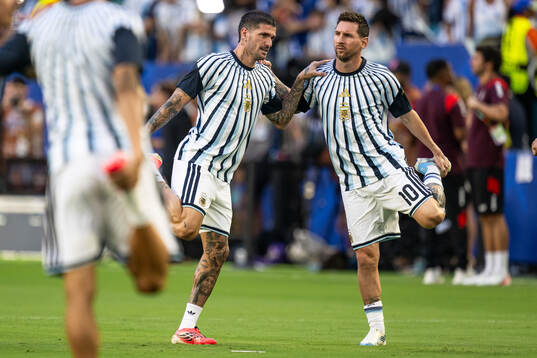 Rodrigo De Paul and Lionel Messi of Argentina