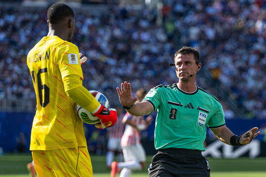 Goalkeeper Mike Maignan of France and Referee Ilgiz