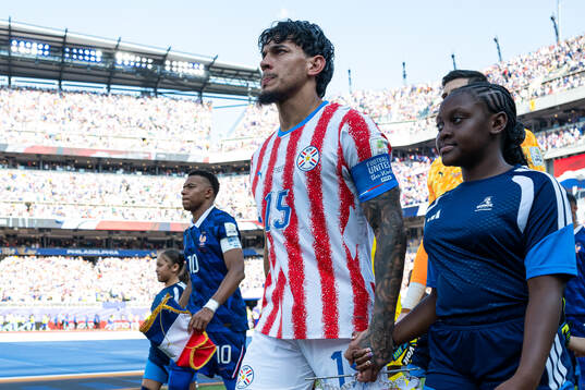 Kylian Mbappe of France and Gustavo Gomez of Paraguay
