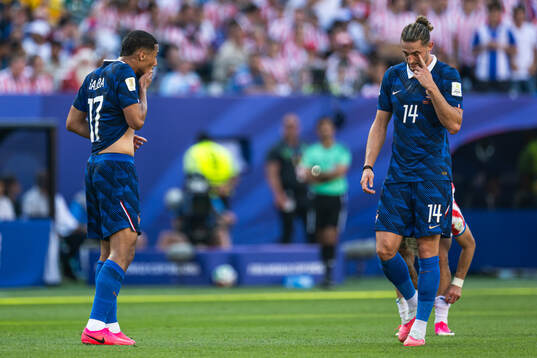 William Saliba and Adrien Rabiot of France looks dejected