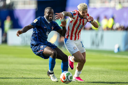 Dayot Upamecano of France and Julio Enciso of Paraguay
