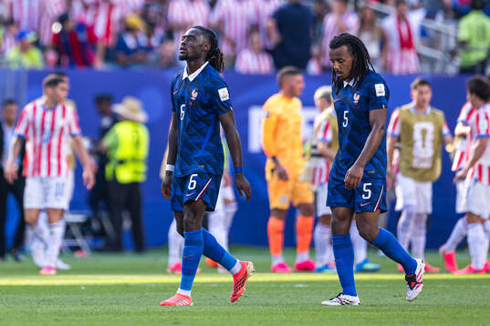 Manu Kone and Jules Kounde of France look dejected
