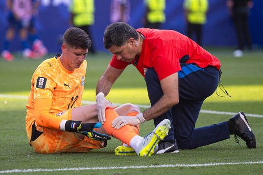 Goalkeeper Orlando Gill of Paraguay receives medical