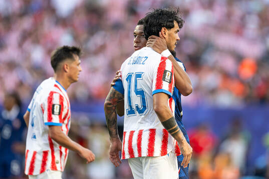 Kylian Mbappe of France and Gustavo Gomez of Paraguay