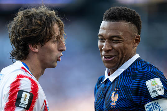Matias Galarza of Paraguay and Kylian Mbappe of France