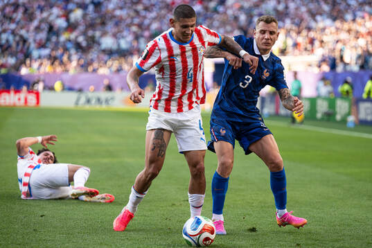 Juan Jose Caceres of Paraguay and Lucas Digne of France