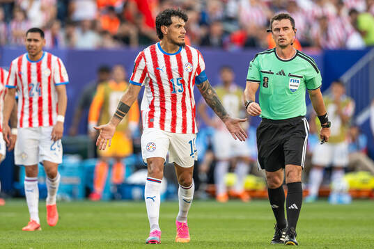 Gustavo Gomez of Paraguay and Referee Ilgiz Tantashev