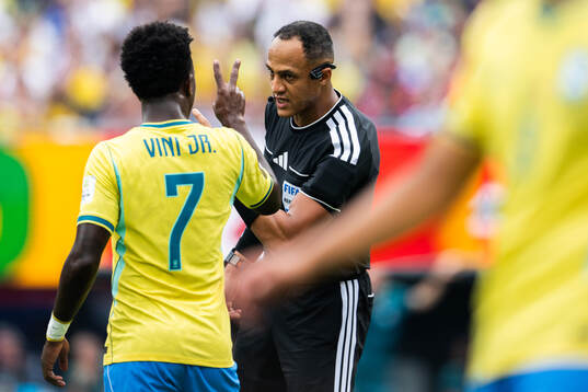 Vinicius Junior of Brazil with referee Ismail Elfath