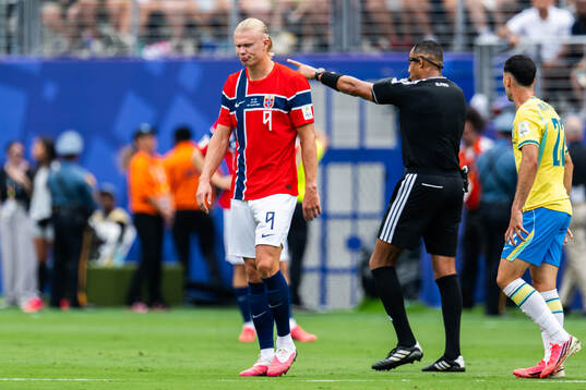 Erling Braut Haaland of Norway and referee Ismail Elfath