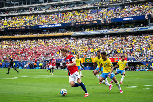 Martin Ødegaard of Norway and Douglas Santos of Brazil