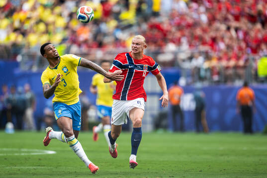 Gabriel Magalhaes of Brazil and Erling Braut Haaland of