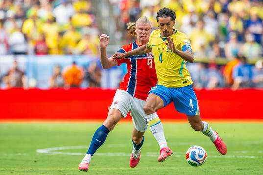 Erling Braut Haaland of Norway and Marquinhos of Brazil