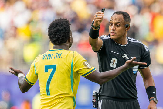 Vinicius Junior of Brazil and referee Ismail Elfath