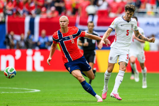 Erling Braut Haaland of Norway and John Stones of England