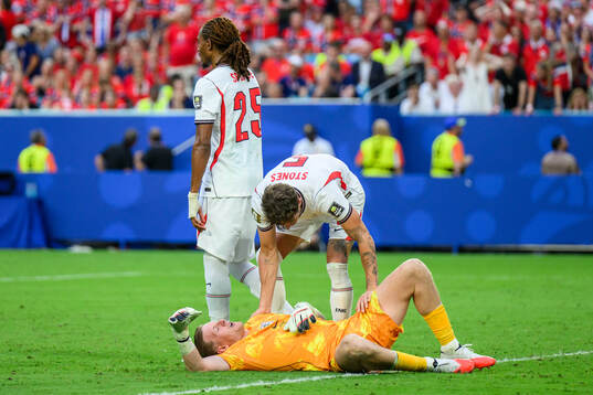 goalkeeper Jordan Pickford of England in pain