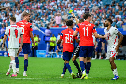 Kristoffer Ajer of Norway is shown a yellow card by Referee