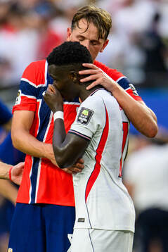 Sander Berge of Norway and Bukayo Saka of England
