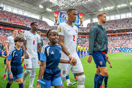 Ezri Konsa of England and Kristoffer Ajer of Norway enter