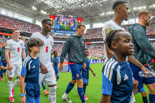 Marc Guehi of England and Sander Berge of Norway enter the