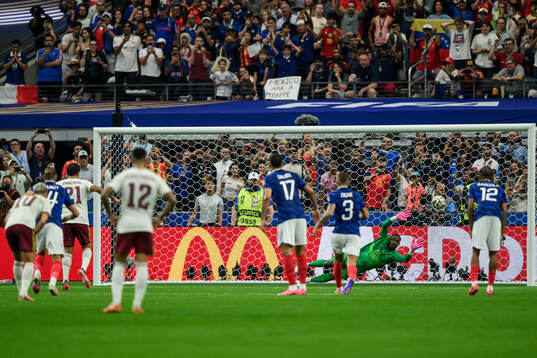goalkeeper Mike Maignan of France concedes a penalty kick