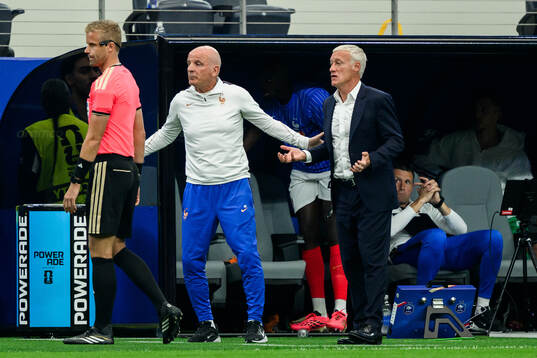 Assistant referee Glenn Nyberg and Head coach Didier Claude