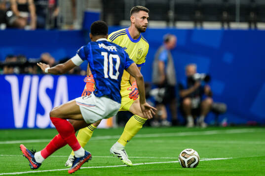 Kylian Mbappe of France and goalkeeper Unai Simon of Spain
