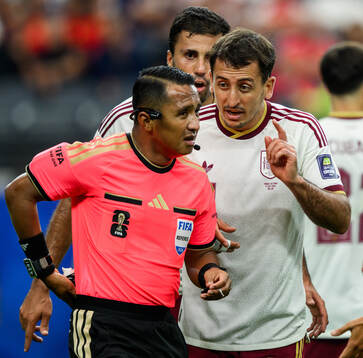 Referee Ivan Barton and Mikel Oyarzabal of Spain
