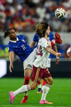 Michael Olise of France and Marc Cucurella of Spain