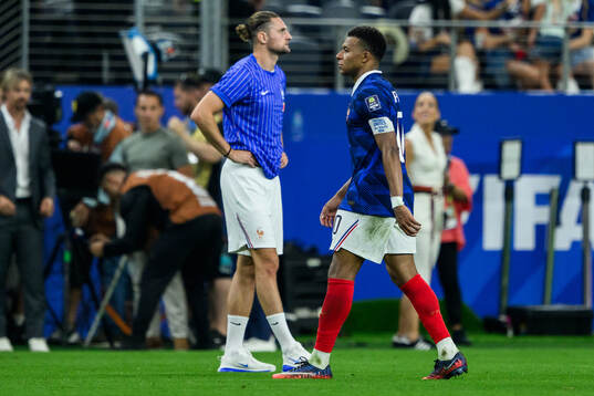 Adrien Rabiot and Kylian Mbappe of France look dejected