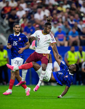 Nico Williams of Spain challenges Maxence Lacroix and