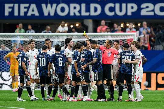 Referee Ismail Elfath and players of England and of