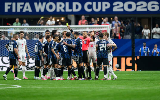 Referee Ismail Elfath and players of England and of