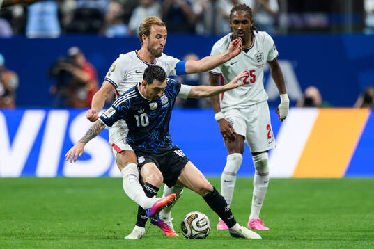 Harry Kane and Djed Spence of England against Lionel Messi