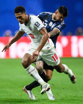 Jude Bellingham of England and Cristian Romero of Argentina