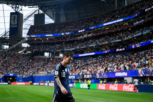 Lionel Messi of Argentina leaves the pitch at half time