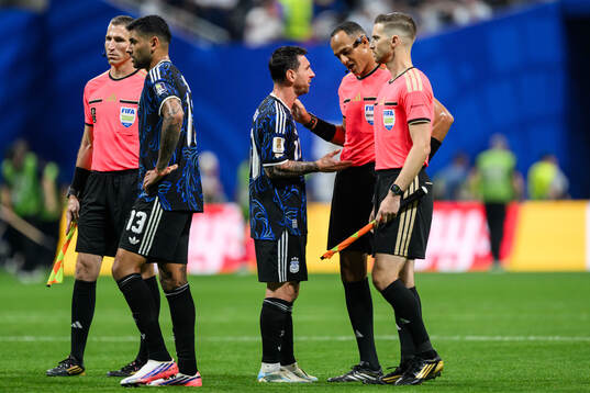 Lionel Messi of Argentina and Referee Ismail Elfath